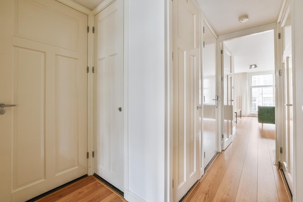 Doorway of modern apartment with white walls and parquet floor