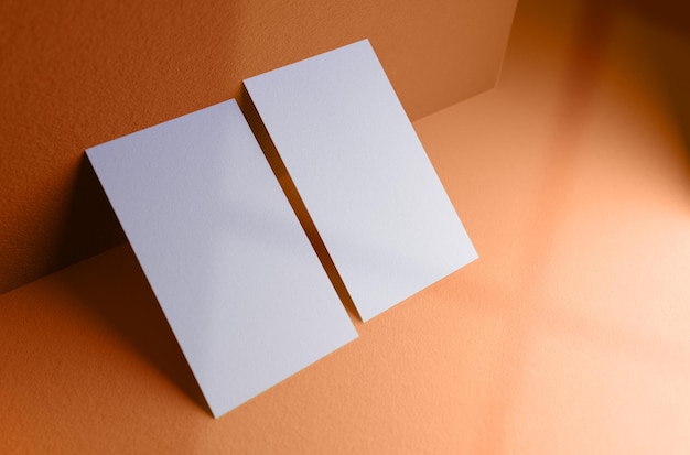 Double business card leaning against the wall mockup template