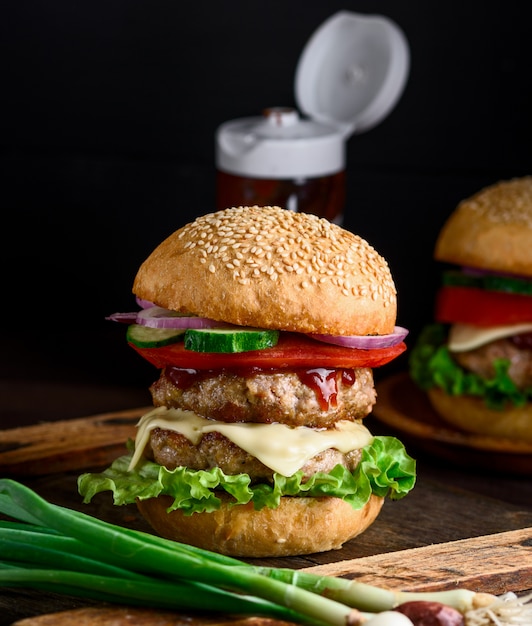 Double cheeseburger in a bun with sesame seeds