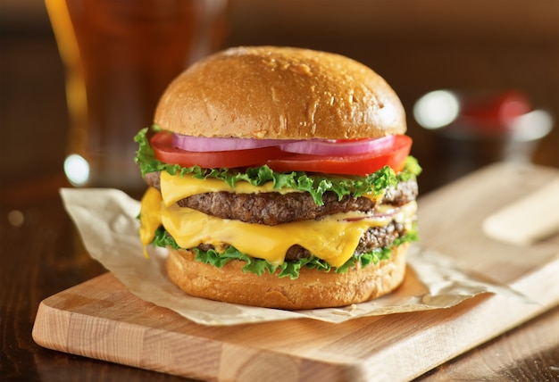 Double cheeseburger with lettuce, tomato, onion, and melted american cheese