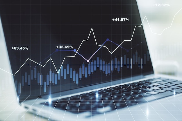 Double exposure of abstract creative financial chart on modern laptop background research and strategy concept