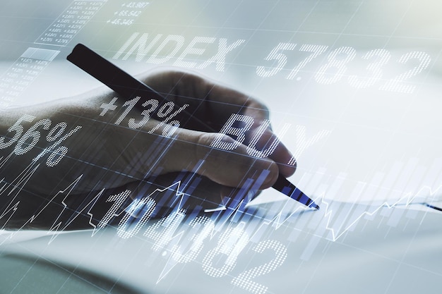 Double exposure of abstract creative financial chart with hand writing in notebook on background research and strategy concept