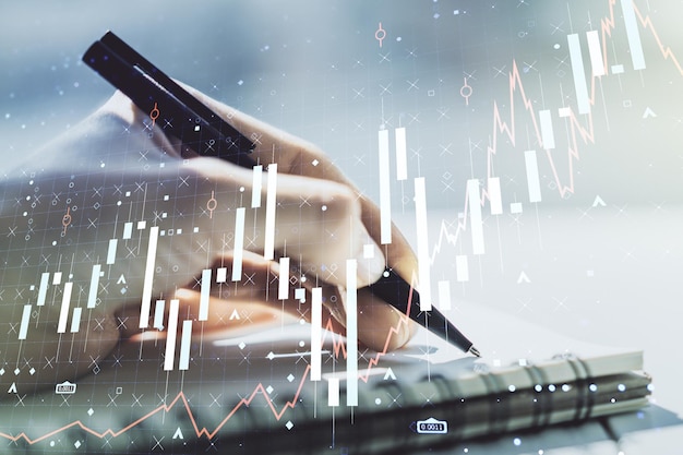 Double exposure of abstract creative financial diagram with hand writing in notebook on background banking and accounting concept