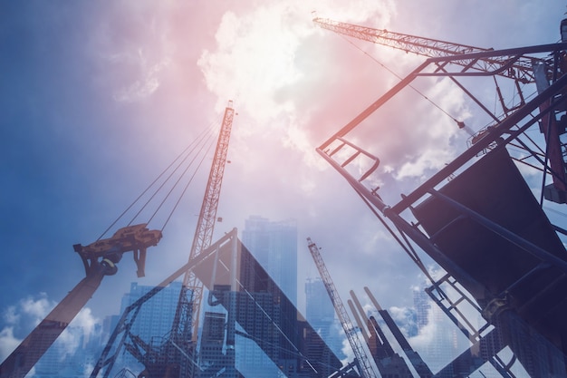 Double exposure of abstract real estate construction site and cityscape buildings