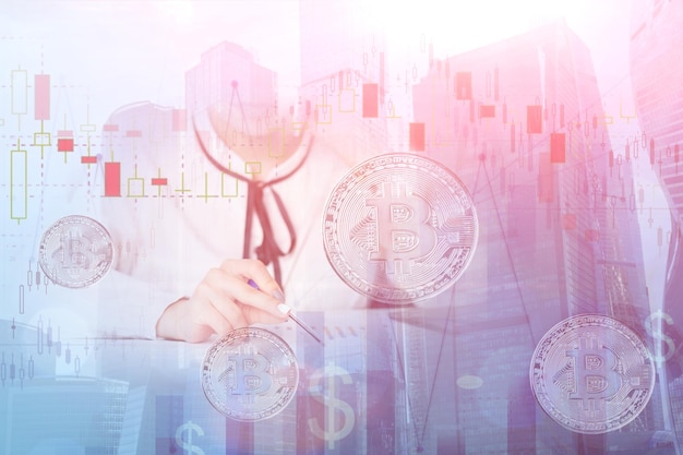 Double exposure business manager on background of skyscrapers with bitcoin financial cryptocurrency charts and trading graphs economic success