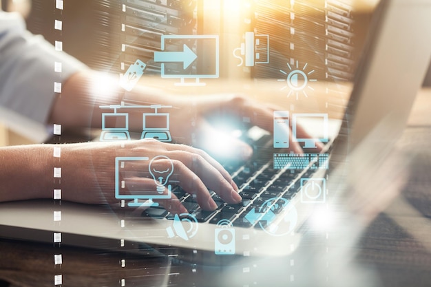 Double exposure of businessman hands working with laptop