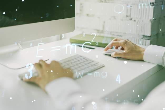 Double exposure of creative scientific formula concept with hands typing on laptop on background research and development concept