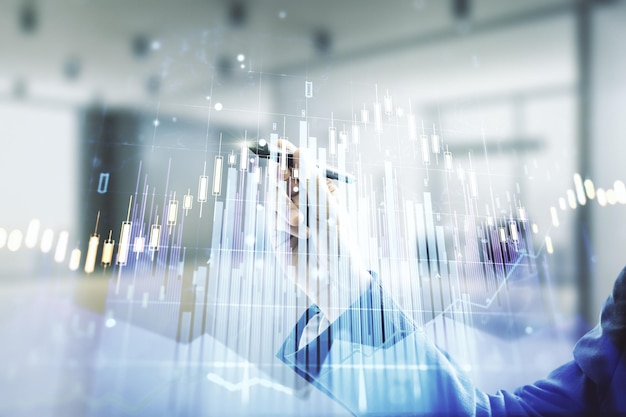 Double exposure of man hand with pen working with virtual creative financial diagram on blurred office background banking and accounting concept