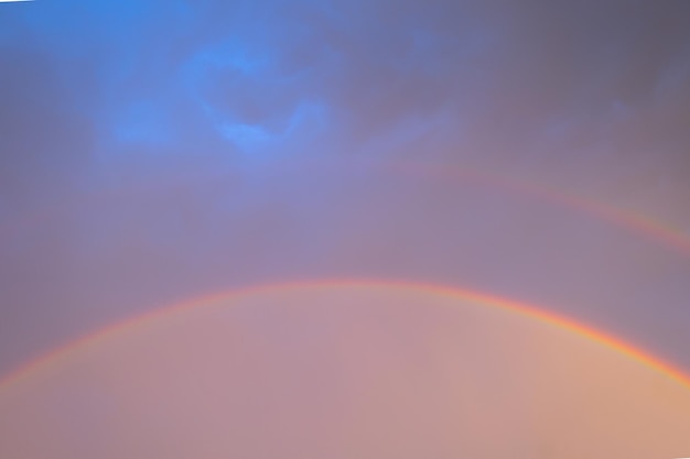 Double rainbow in dark sky after rain