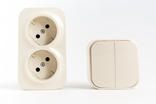 Double socket and twokey light switch on white background