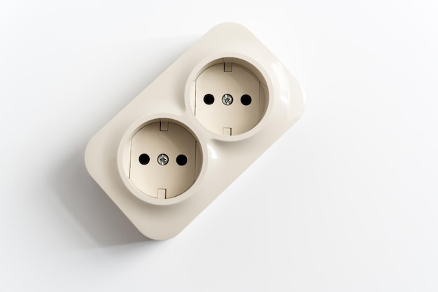 Double socket on a white background two sockets united by one monolithic case