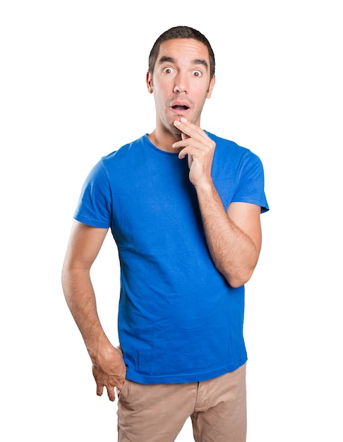 Doubtful young man against white background