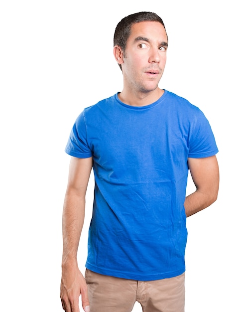 Doubtful young man against white background