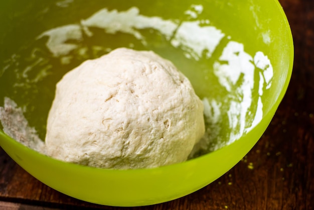 Dough ball in plastic bowl Preparation of yeast dough for making bread pizza bases