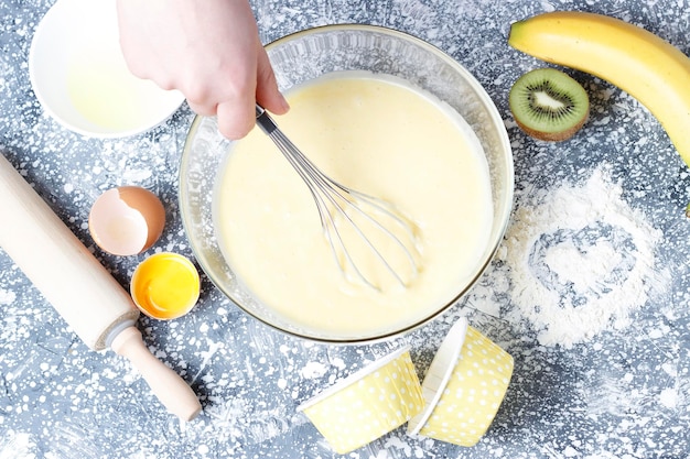 A dough in bowl and whisk top view home baking cooking concept