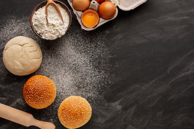 Dough and buns with flour and sesame seeds