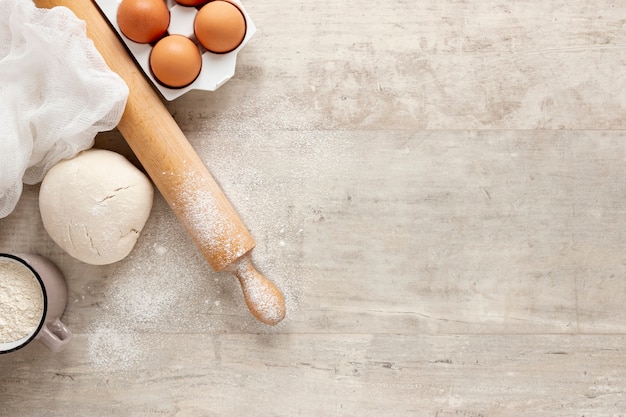 Dough eggs and kitchen roller with copy space