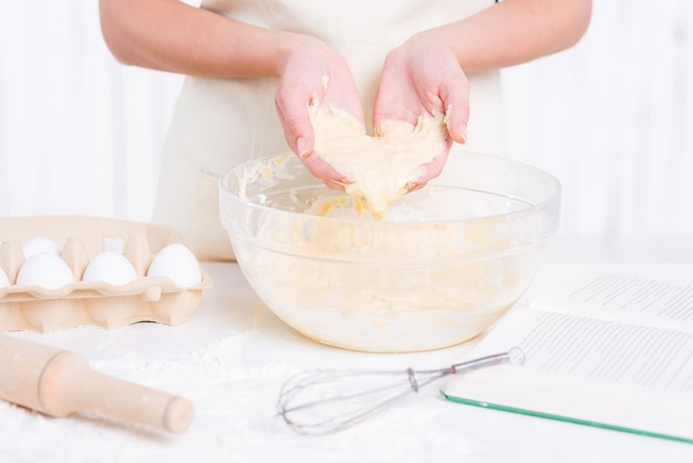 Dough in her hands. Close-up of woman holding dough in hands