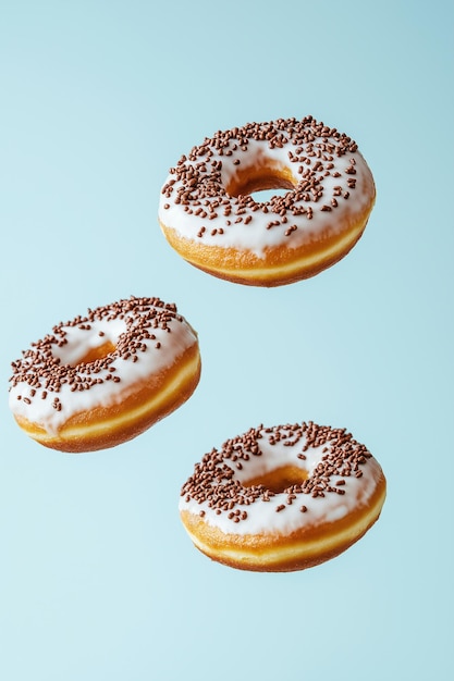 Doughnuts with white glaze and chocolate sprinkles