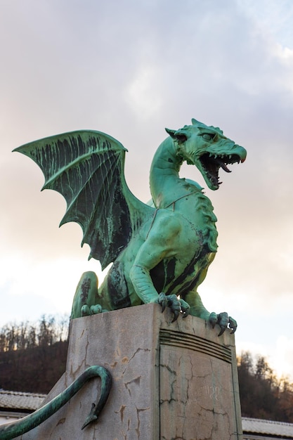 Dragon Copper Statue on Dragon Bridge in a cloudy day in Ljubljana capital of Slovenia