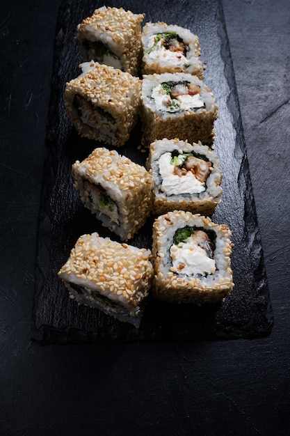 Dragon eel sushi rolls in sesame seeds