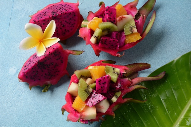 Dragon fruit (Pitaya, Pitahaya).Sliced pieces pitahaya fruit and fruit salad,and frangipani flowers.