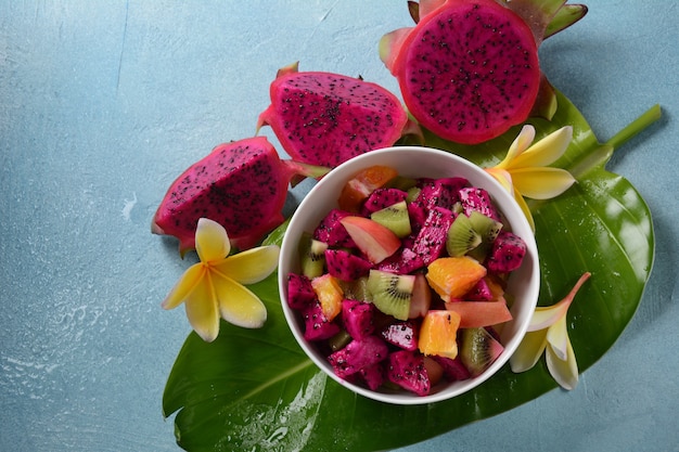 Dragon fruit (Pitaya, Pitahaya).Sliced pieces pitahaya fruit and fruit salad,and frangipani flowers.