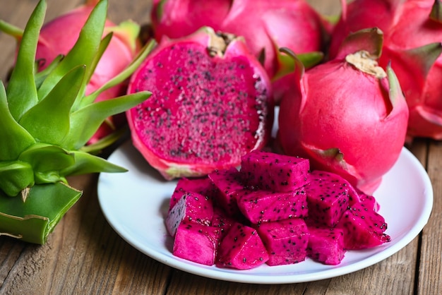 Dragon fruit slice and cut half on white plate with pitahaya background fresh pink red purple dragon fruit tropical in the asian thailand healthy fruit concept