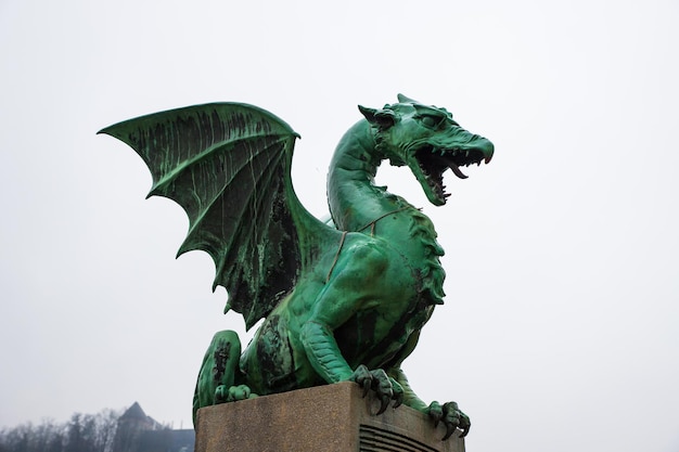 Dragon Statue on Dragon Bridge on winter day in Ljubljana capital of Slovenia