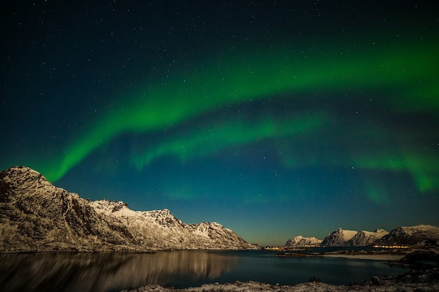 Dramatic aurora borealis, polar lights, over mountains in the North of Europe