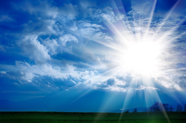 Dramatic clouds with sun on the blue sky on the sunset