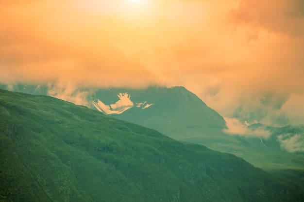 Dramatic evening cloudy sky over mountains peaks Sunset over the mountains