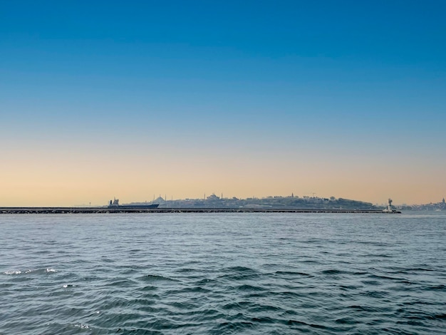 Dramatic landscape photo of Istanbul silhouette with Hagia Sophia at sunset by the sea