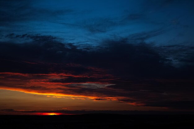 Dramatic landscape of sunset with dark colourful clouds Natural background