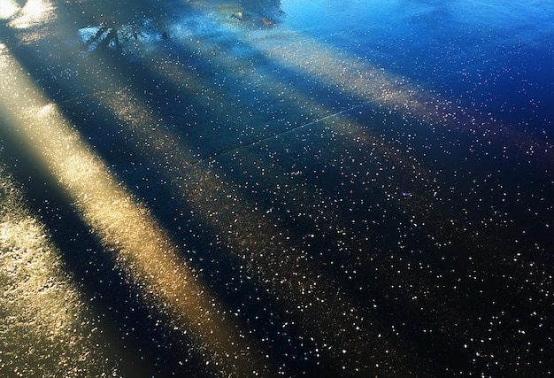 Dramatic light rays on street asphalt backdrop