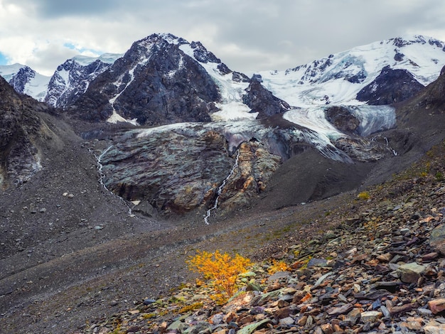 Dramatic natural background of the glacier surface with cracks Natural background of the ice wall and the glacier in the background Beautiful natural texture of a dark glacier wall