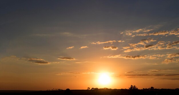 Dramatic Natural Sunset Sunrise Over farm field Countryside Landscape Under Scenic Colorful Sky At Sundown