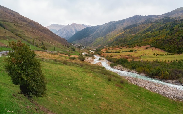 Dramatic panoramic view of amazing mountain stormy Khares River in North Ossetia Awesome highland scenery with beautiful glacial streams among rainy hills and rocks Caucasus Mountains