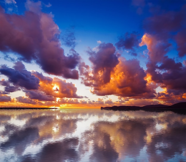 Dramatic sky reflected in the water at sunset