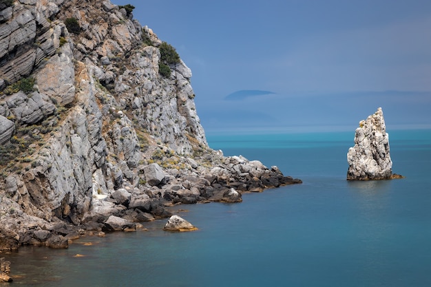 Dramatic sky over the rocky coast and the Parus rock on the Black Sea coast