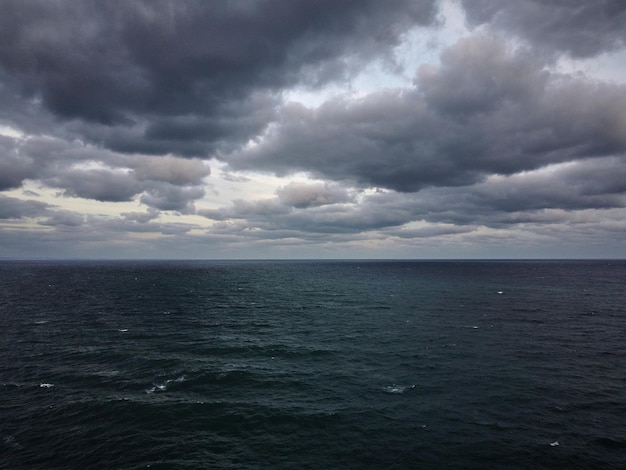 Dramatic sky over stormy dark sea aerial view