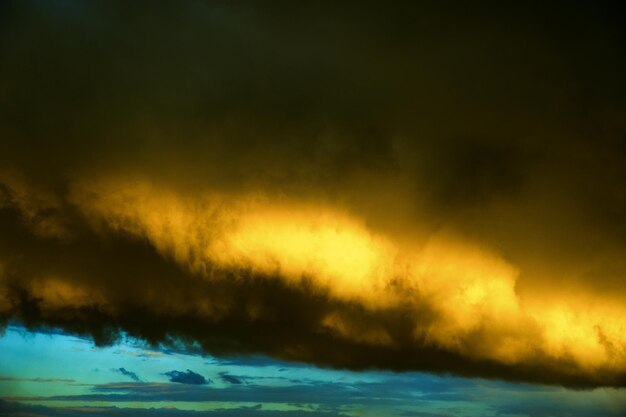 Dramatic sky with storm deep blue and yellow clouds