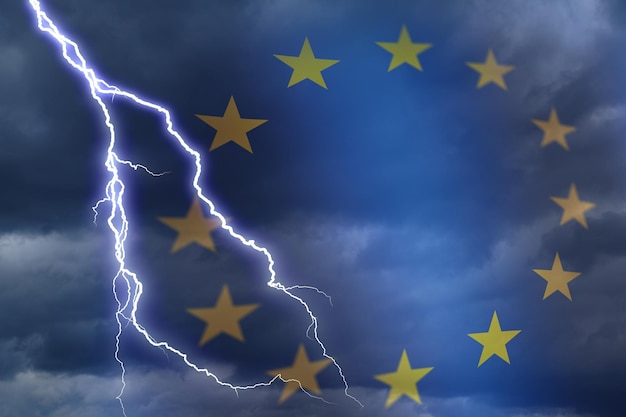 Dramatic stormy clouds with lightning next to EU stars flag symbol Upcoming crisis and economy problems in Europe