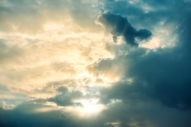 Dramatic sunset Fantasy landscape with clouds and sun rays Sun light throw storm clouds Magic sunbeams and storm clouds on heaven