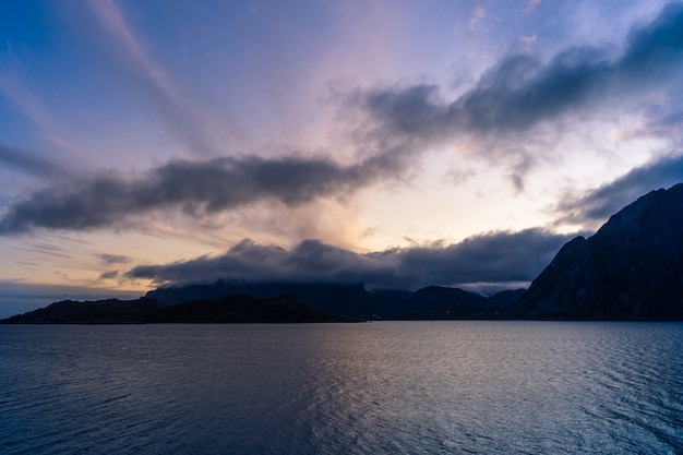 Dramatic sunset landscape with sea and mountains in Lofoten, Norway