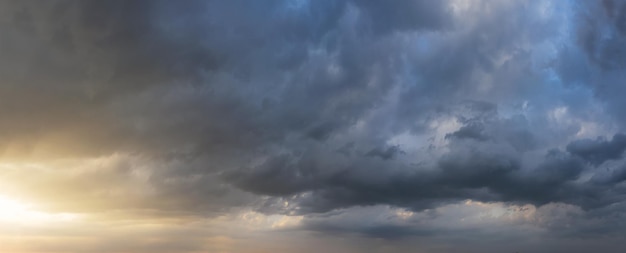 Dramatic sunset sky with dark rainy clouds Nature background Sky panorama