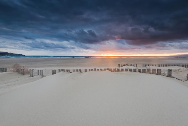 Dramatic sunset and storm clouds over beach in Tarifa Spain