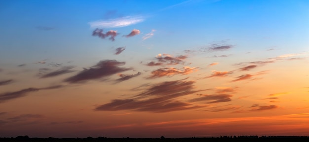 Dramatic sunset, the sun's rays shine through the clouds.