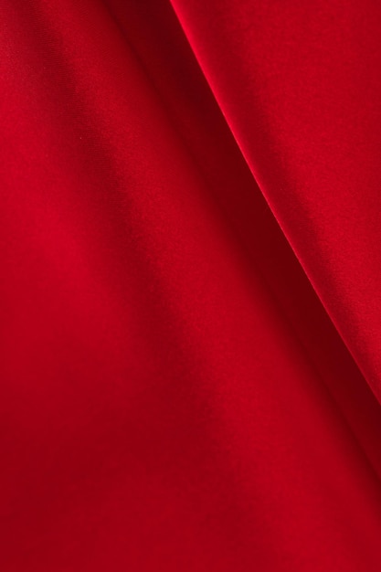 Draped red silk fabric of satin weave texture background