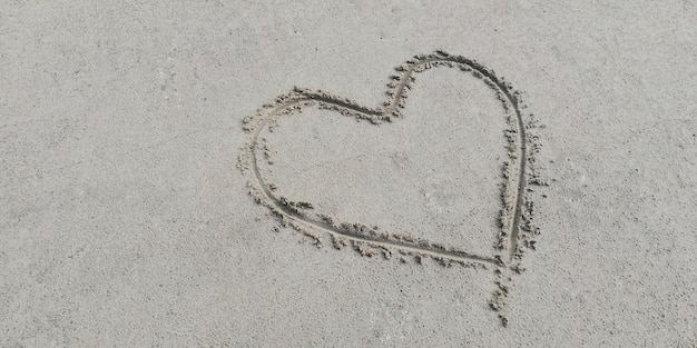 Draw heart on the sand.